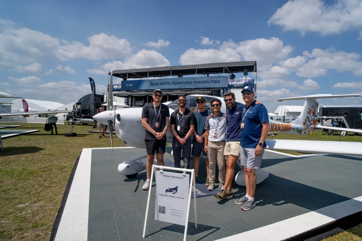 Peregrine Howard team standing with a Diamond DA42 on the Sun ’n Fun display pad