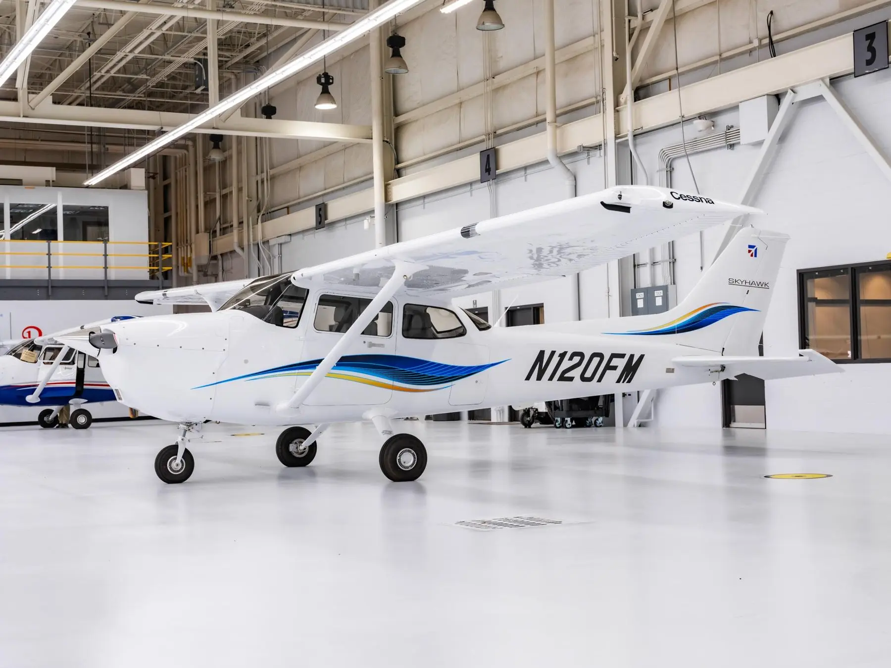 A new Cessna 172 Skyhawk, N120FM, on the hangar floor at delivery