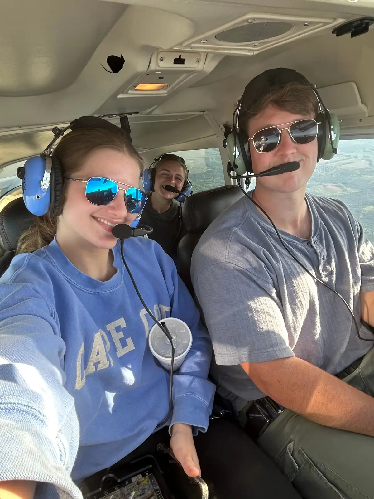 A.J. Dorizas at the controls with two passengers on a flight