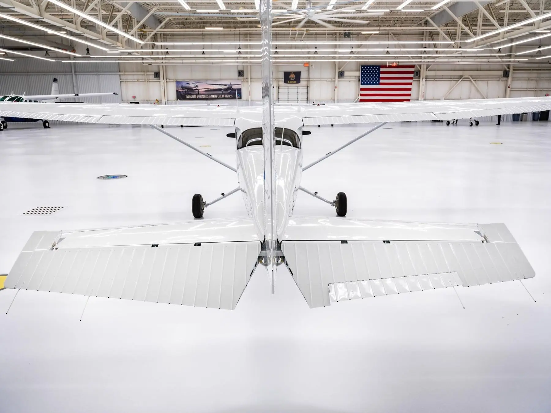 View under the wing of a trainer in a hangar