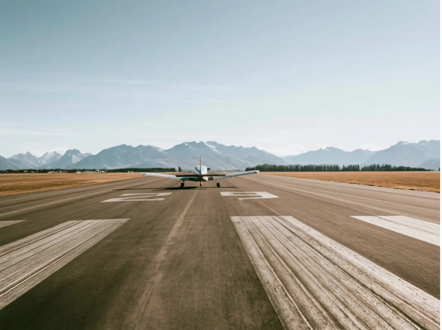 A trainer aircraft holding on runway 23, mountains ahead