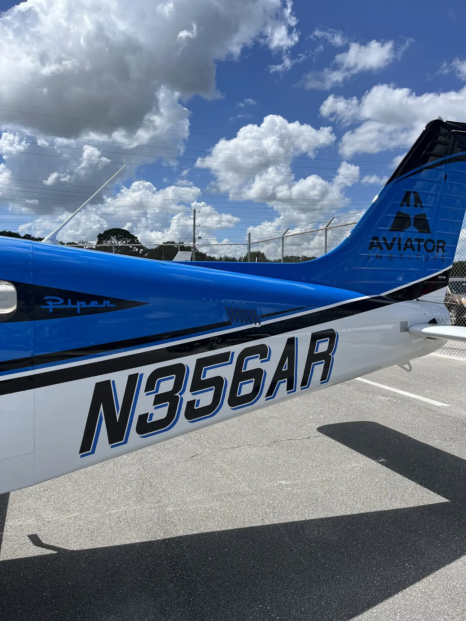 The blue and white tail of N356AR against the sky